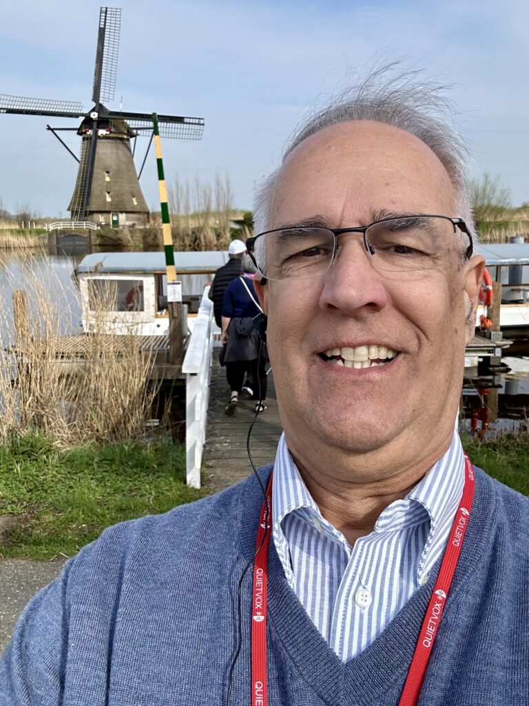 River & Vine Travel owner touring a Dutch windmill village on a European river cruise shore excursion.